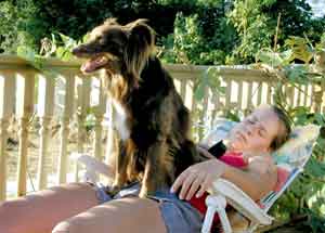 Au Pair Dog Carers Rebekah sitting on Anna in the sun